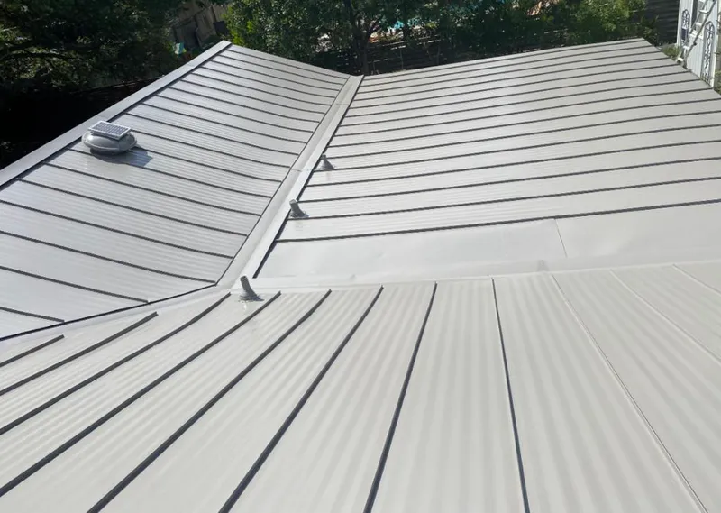 Solar attic fan installed on a metal roof for Roof Ventilation in Deerfield